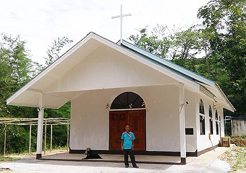 Pastor Daom in front of his new church.