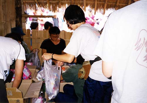 Helping giving supplies to needy villagers