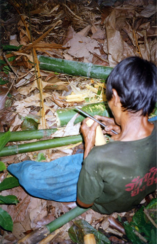 Making bamboo cups in the jungle.